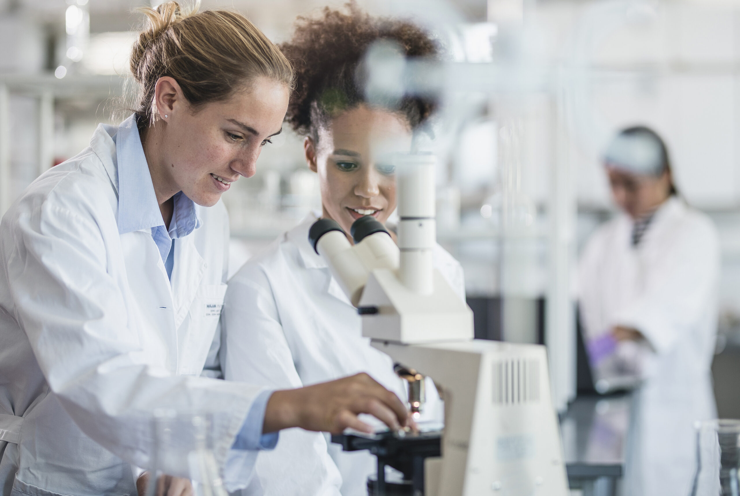 Women Scientists Looking Through Microscope